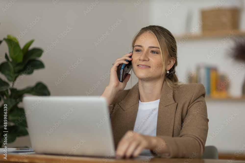 Young woman working at home with laptop and papers on desk. Home office concept. Young woman working at home with laptop and papers on desk. Home office concept.