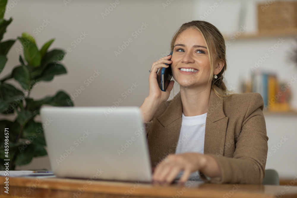 Young woman working at home with laptop and papers on desk. Home office concept. Young woman working at home with laptop and papers on desk. Home office concept.
