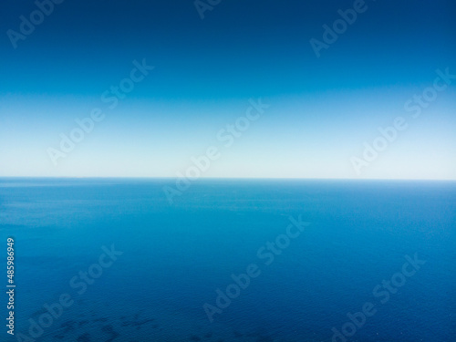 Seascape against blue clear sky