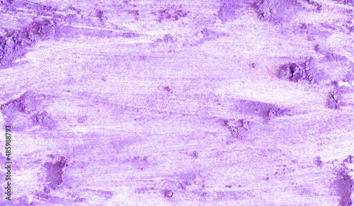 Colored powder on a white background. Purple eyeshadows are scattered and smeared, makeup. Holi Colorful festival of colored paints powders and dust. A holiday of bright colors to entertain people.
