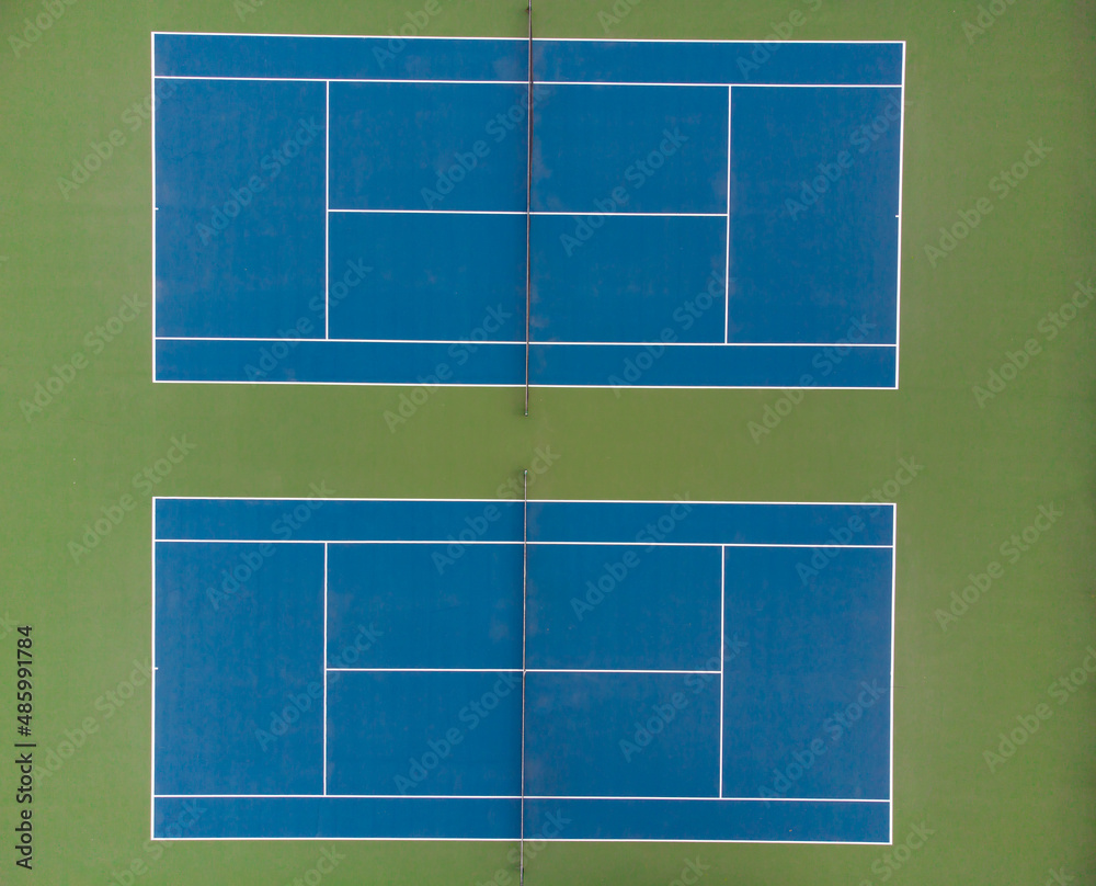 View from above. Two tennis courts. Minimalism. There are no people in the photo. Sports, amateur and professional sports, recreation, relaxation, healthy lifestyle.