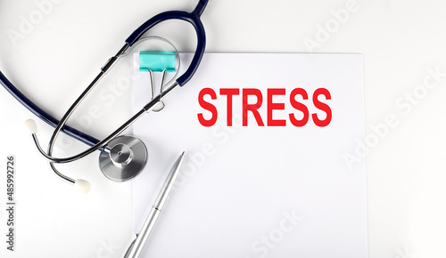 STRESS text written on the paper with a stethoscope. Medical concept.