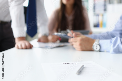 Businesspeople having meeting in conference room, contract paper with pen on desk