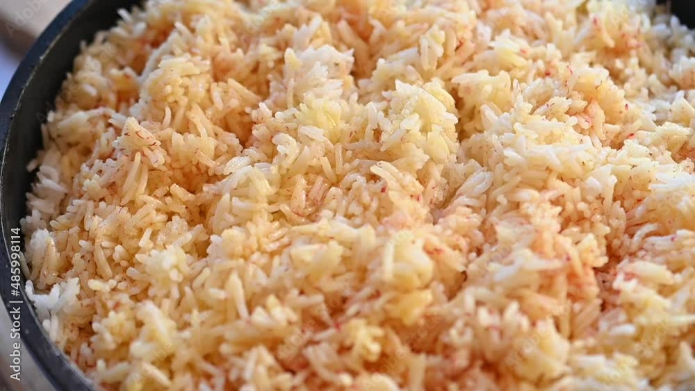The cook prepares rice in a pan The cook prepares rice in a pan