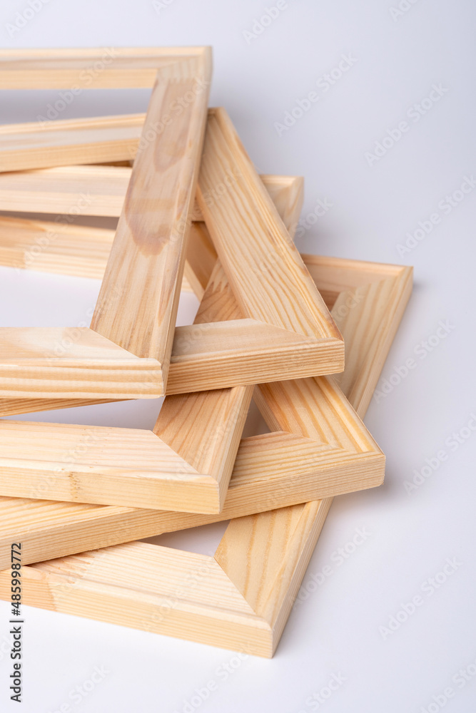 A stack of wooden stretchers for stretching the canvas lies on a white background.