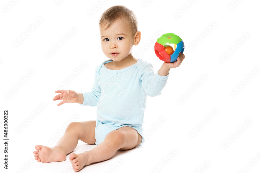 Little boy in romper sitting and playing with plastic toy. Little boy in romper sitting and playing with plastic toy.