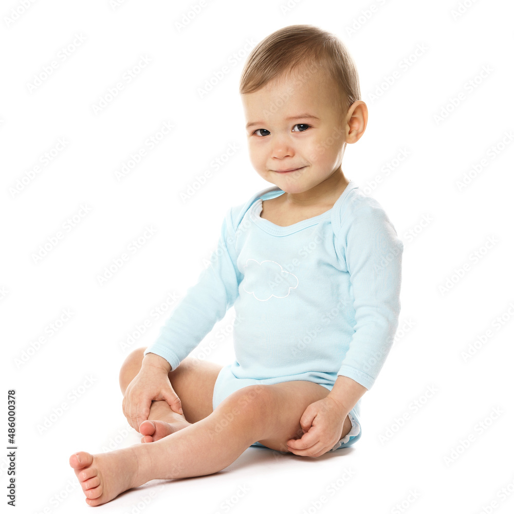 Curious little boy in romper sitting and smiling. Curious little boy in romper sitting and smiling.