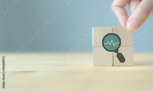 Annual medical health check up healthcare concept. Digital health check. Medical or health insurrance business. Hand puts the wooden cubes with health check up icon on grey background and copy space.