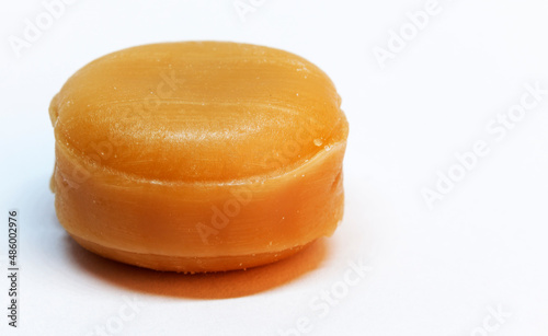 caramel candy without paper on white background