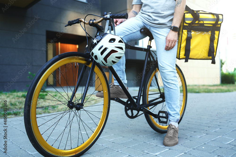 Express delivery courier with insulated bag sitting on bicycle. Express delivery courier with insulated bag sitting on bicycle.
