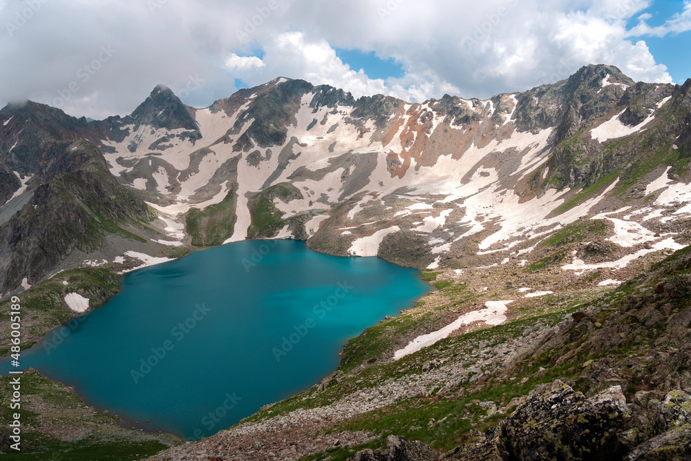 High-mountain lake Murudzhinskoye in the Teberda Biosphere Reserve with snow High-mountain lake Murudzhinskoye in the Teberda Biosphere Reserve with snow