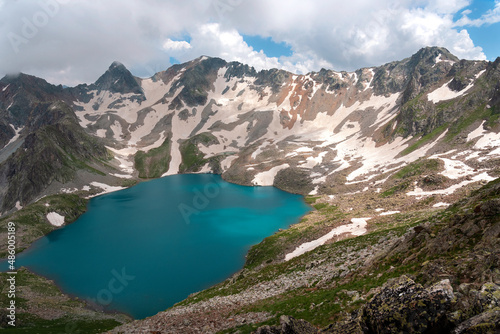High-mountain lake Murudzhinskoye in the Teberda Biosphere Reserve with snow