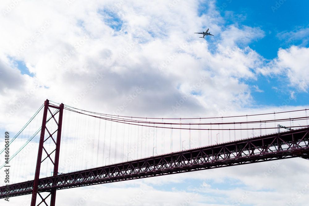 April 25 bridge from below as an airplane passes overhead in Lisbon