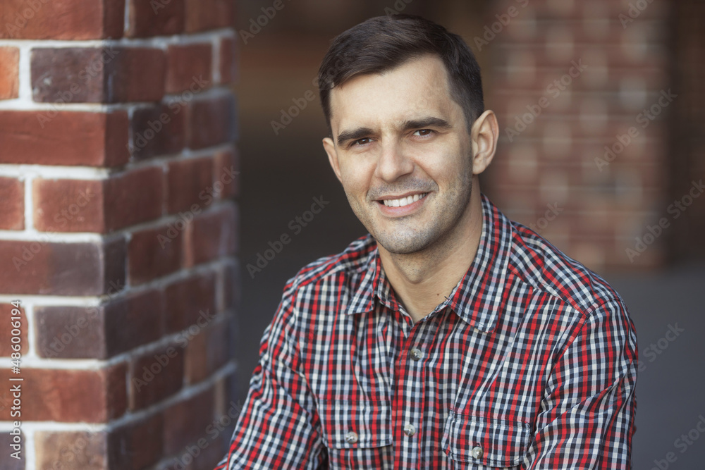 Close up street portrait of smiling millennial handsome man 30-35 years old in casual clothes Close up street portrait of smiling millennial handsome man 30-35 years old in casual clothes