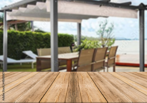 Wooden board empty table blurred background modern summer house gazebo terrace © pedro