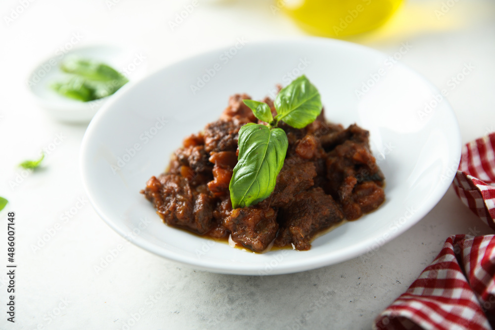 Homemade beef ragout with fresh basil
