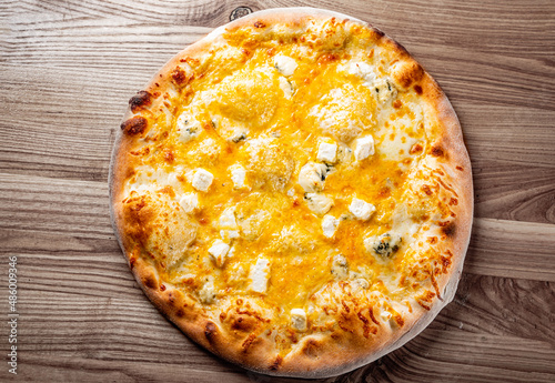 Quattro Formaggio (Four Cheese) Pizza. Italian pizza on wooden table background