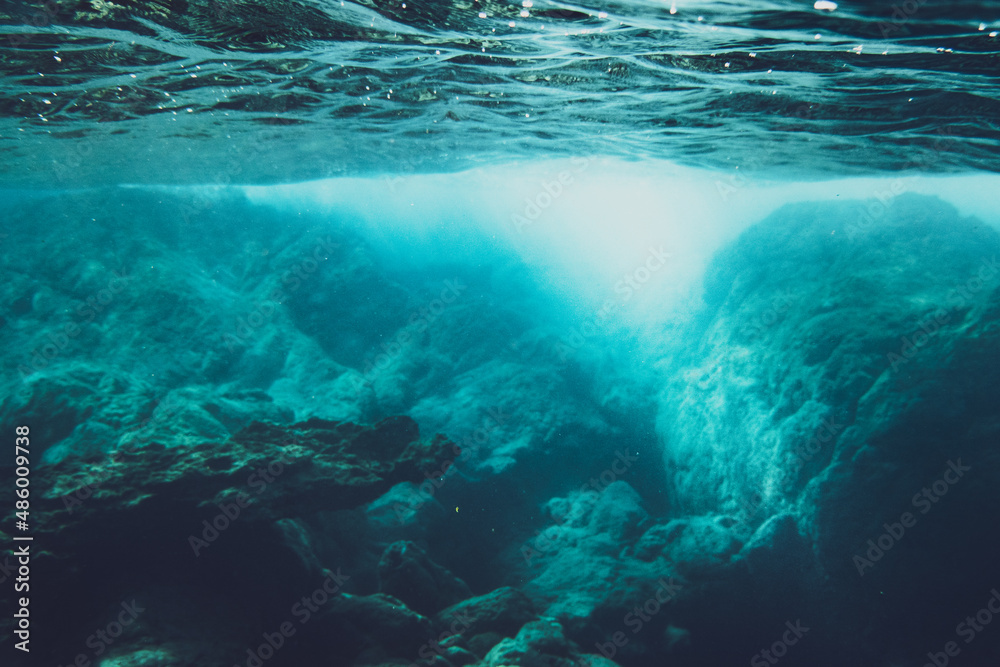 Underwater scene with sunlight on rocks