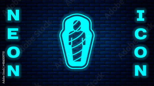 Glowing neon Egypt mummy in sarcophagus icon isolated on brick wall background. Vector