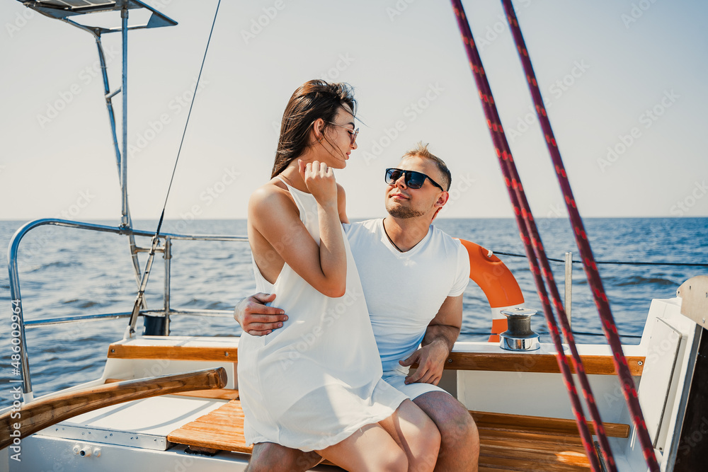 Young couple have romantic walk on the yacht and relaxing. Weekend at sea. Travel concept Young couple have romantic walk on the yacht and relaxing. Weekend at sea. Travel concept