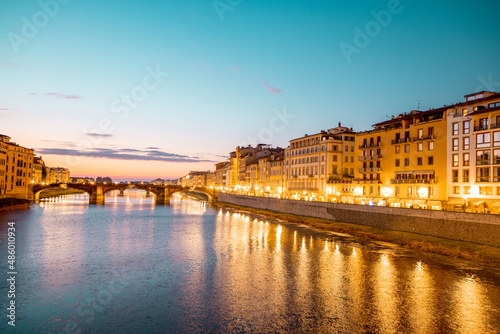 Landscape of Florence old town, night view from the bridge on Arno river and riverside. Beautiful sunset cityscape of Firenze, Italy