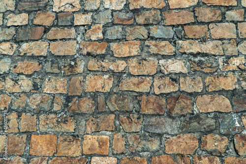 Texture of an ancient stone wall made of bricks