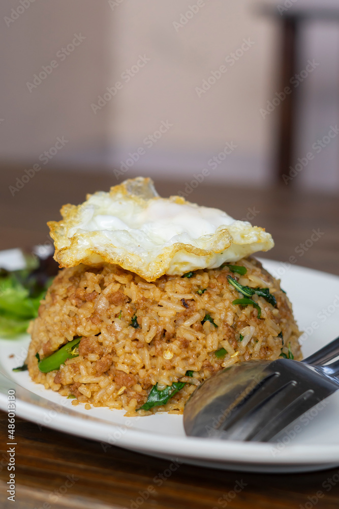 Rice topped with stir-fried pork
and basil.Thai street food.Stir fried basil. Rice topped with stir-fried pork
and basil.Thai street food.Stir fried basil.