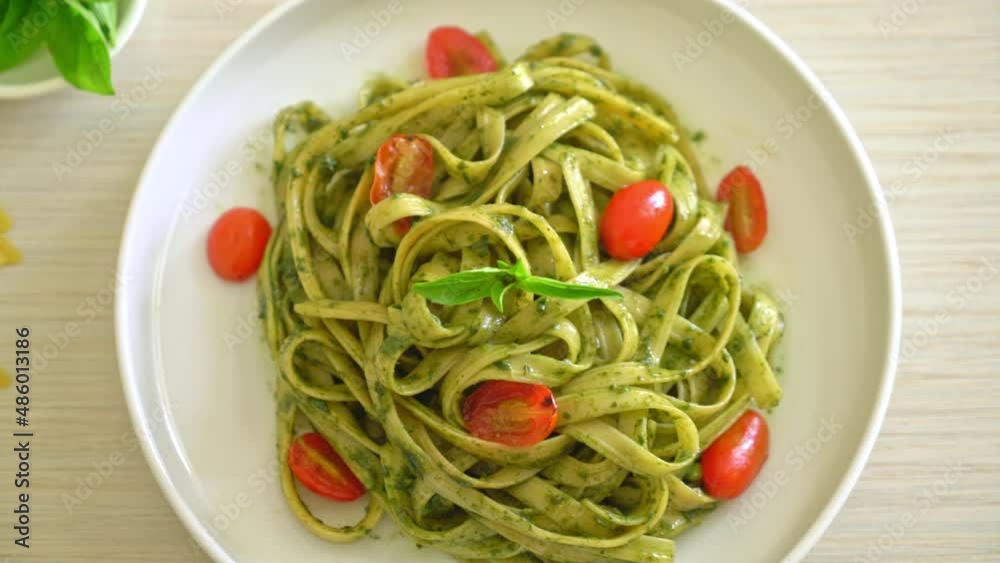 fettuccine spaghetti pasta with pesto sauce and tomatoes - vegan and vegetarian food style fettuccine spaghetti pasta with pesto sauce and tomatoes - vegan and vegetarian food style
