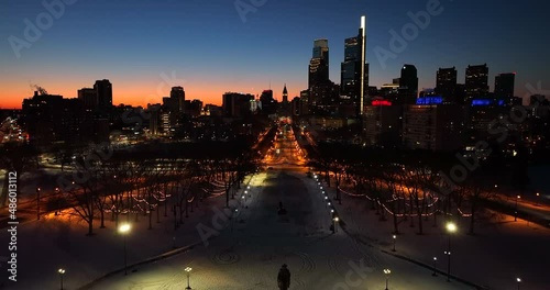 Philadelphia skyline. Rising aerial at colorful winter sunrise in snow. Aerial drone shot. photo