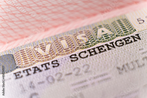 Macro shot biometric passport with schengen visa. European visitor visa for tourism and travel in EU photo