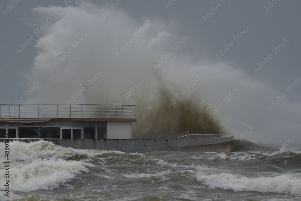 WEATHER - Pier and hurricane on the sea coast 