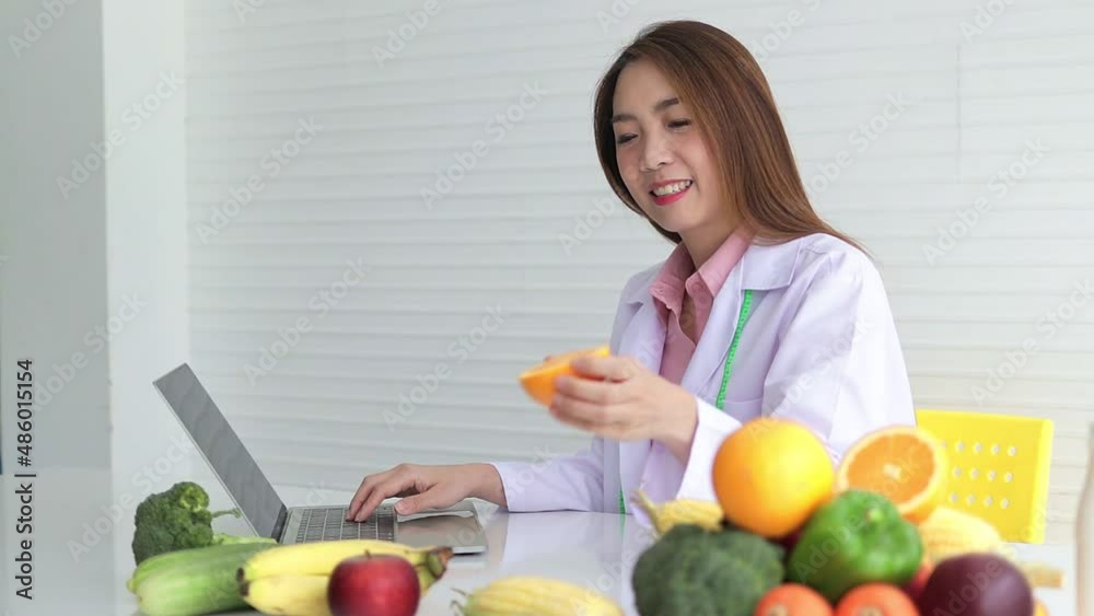 Asian female doctor or nutritionist Consulting the patient about the diet There were various fruits and vegetables lying on the white table. health care concepts, healthy eating, weight loss Asian female doctor or nutritionist Consulting the patient about the diet There were various fruits and vegetables lying on the white table. health care concepts, healthy eating, weight loss