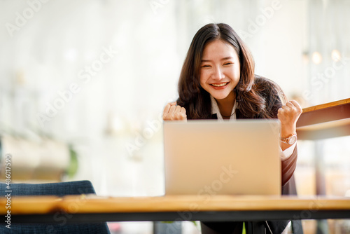 Excited Asian woman at desk feel euphoric win online lottery, happy black woman overjoyed get mail at laptop being promoted at work, biracial girl amazed read good news at computer