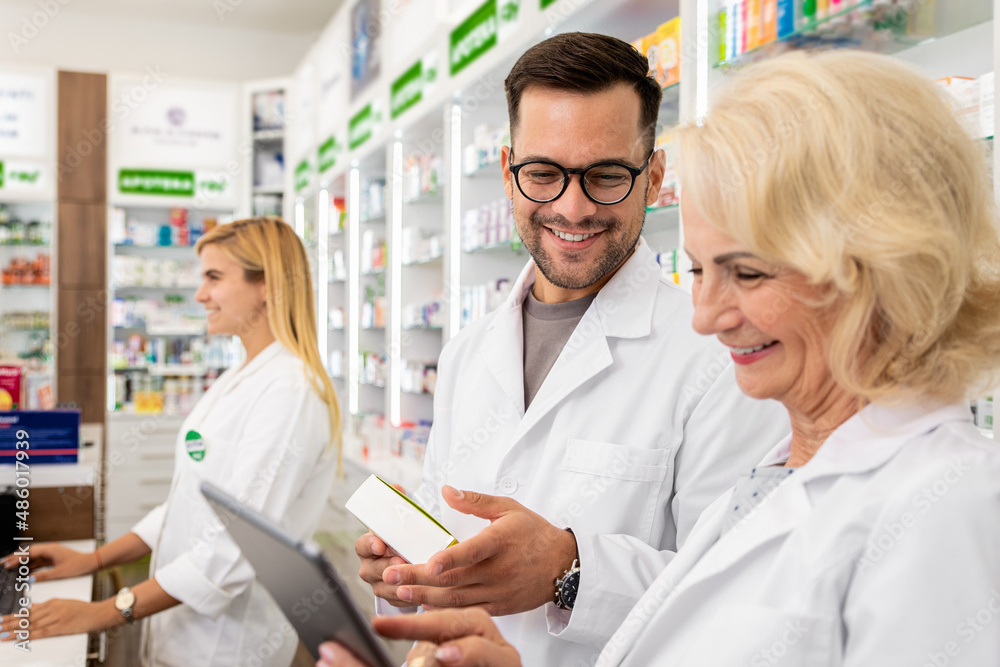 Portrait of two pharmacist working  in drugstore.