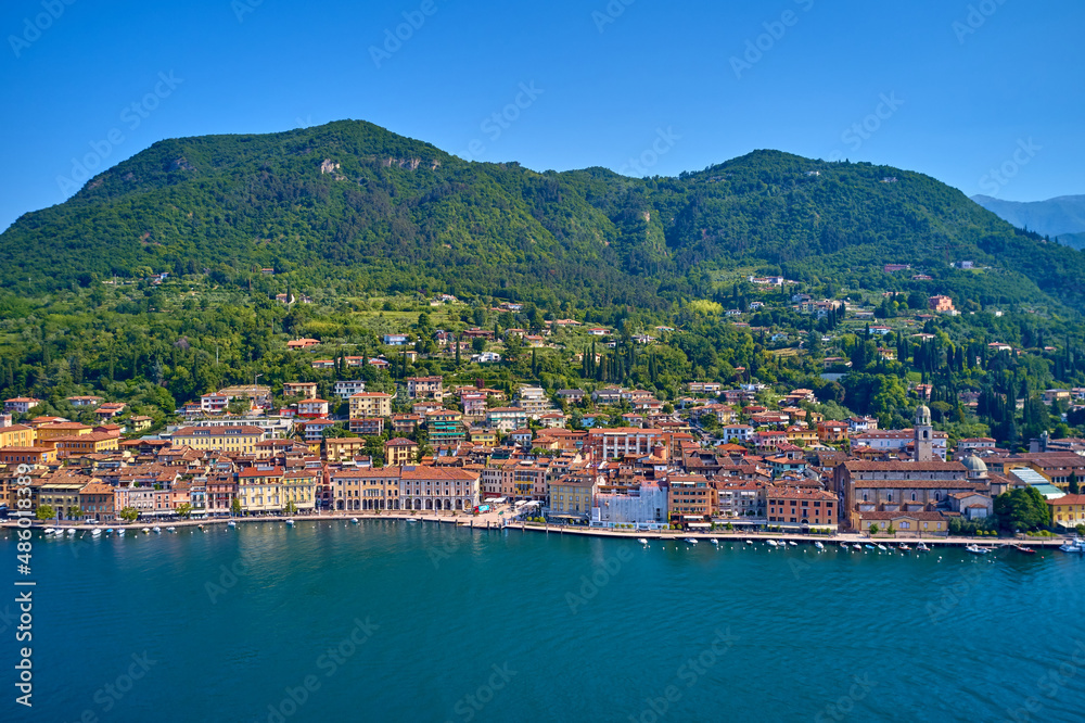 Panoramic view of the historic part of Salò on Lake Garda Italy. Special View by Drone - Flying in Garda lake - Salò for an italian summer. Tourist on the lake.