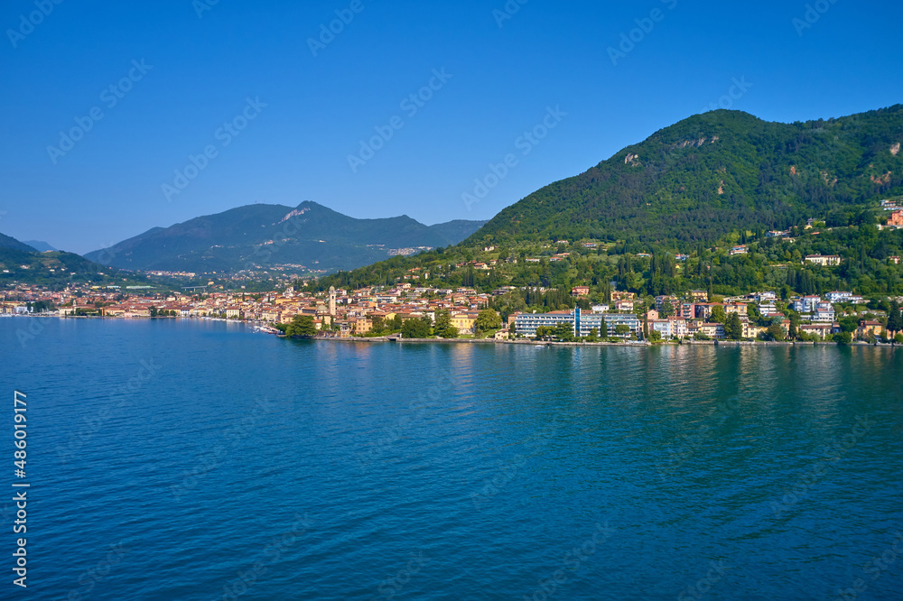 Lake in the mountains of Italy. Aerial view of the town on Lake Garda. Panoramic view of the historic part of Salò on Lake Garda Italy. Tourist site on Lake Garda.