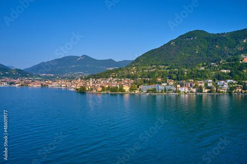 Lake in the mountains of Italy. Aerial view of the town on Lake Garda. Panoramic view of the historic part of Salò on Lake Garda Italy. Tourist site on Lake Garda.