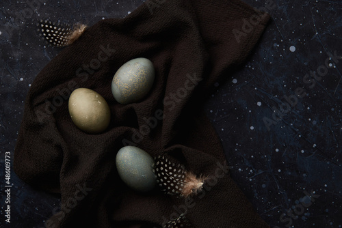 Dyed eggs on black background. Easter celebration concept