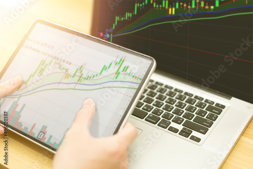 graph in computer and mobile show finance business and stock market volatility