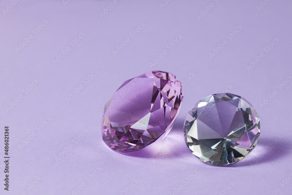 Purple precious gemstones for design gems jewellery. Diamonds crystal on turquoise background.