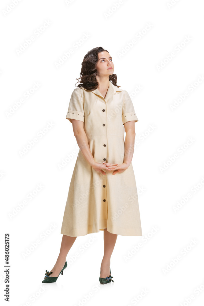 Young beautiful girl in retro style dress, fashion of 70s, 80s years posing isolated on white studio background with copyspace for ad. Young beautiful girl in retro style dress, fashion of 70s, 80s years posing isolated on white studio background with copyspace for ad.