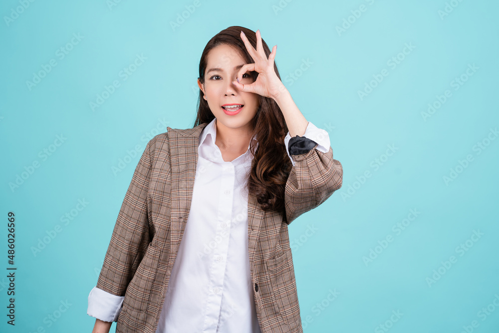 Portrait of happy asian young woman gesture or showing hand ok and looking at camera isolated on green background, Female feeling positive and enjoy concept Portrait of happy asian young woman gesture or showing hand ok and looking at camera isolated on green background, Female feeling positive and enjoy concept