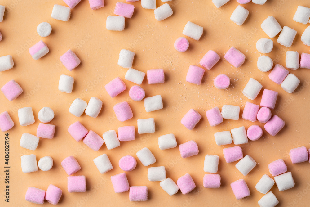 Fluffy marshmallows on beige studio background, top view
