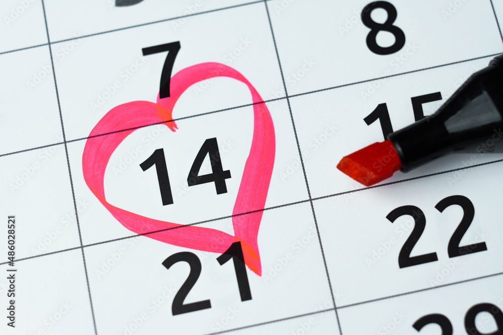 14 february marked with heart in calendar with red marker. St. Valentines day, anniversary. Close up 14 february marked with heart in calendar with red marker. St. Valentines day, anniversary. Close up