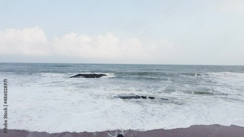 Woman with drone remote control in sea waves, Elmina, Ghana Woman with drone remote control in sea waves, Elmina, Ghana