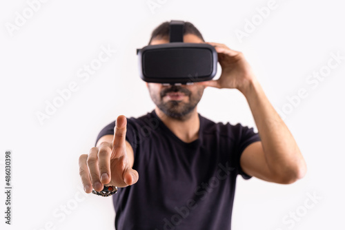 Young man in VR glasses headset gesturing portrait. Virtual reality, future technology, education video gaming