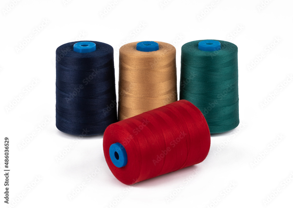 Spool of sewing thread, isolated on white background. Colored yarns used by factories in the clothing industry. Threads wound on the spool. Colored reels Spool of sewing thread, isolated on white background. Colored yarns used by factories in the clothing industry. Threads wound on the spool. Colored reels