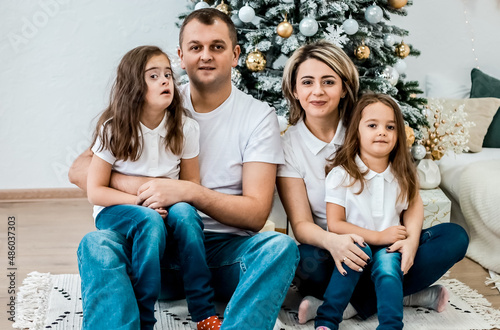 Happy family and New Year's fairy tale. Girl with down syndrome