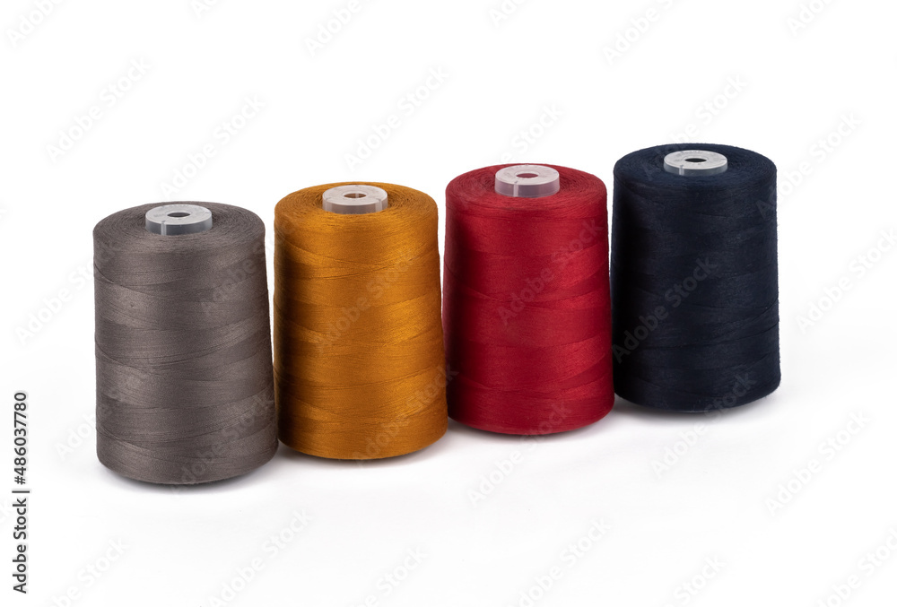 Spool of sewing thread, isolated on white background. Colored yarns used by factories in the clothing industry. Threads wound on the spool. Colored reels Spool of sewing thread, isolated on white background. Colored yarns used by factories in the clothing industry. Threads wound on the spool. Colored reels