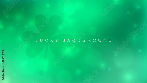 Saint Patrick's Day blurred background with shamrock. Abstract green blurred color gradient banner with bokeh effect. Template for your holiday graphic design. Vector illustration.